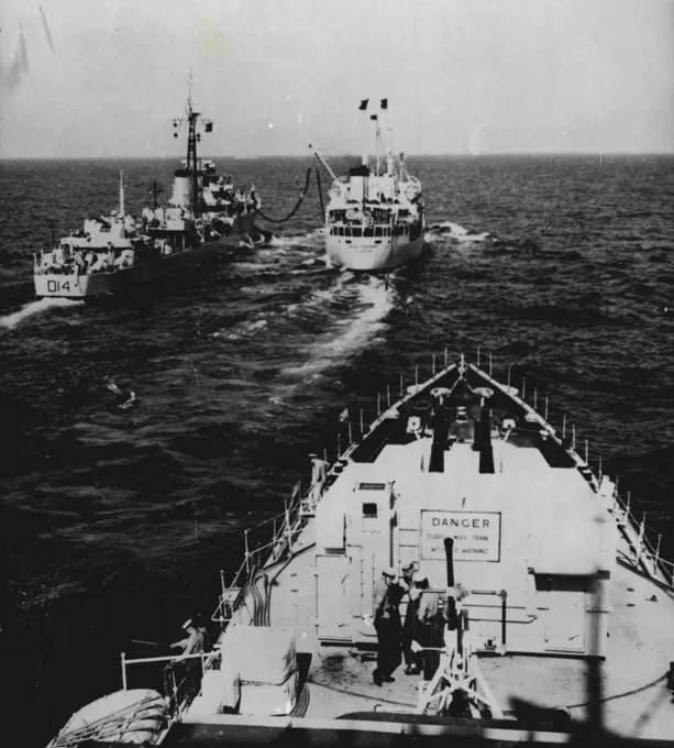 Two Warships Refuel Together -- Refuelling together from the same Fleet Auxiliary, Blue Ranger (far right) are HMS Armada (D14) and HMS Vigo (foreground).The Vigo is taking in oil from a pipe trailed astern of the Blue Ranger.The exercise took place during replenishment and transfer at sea practices carried out off the coast of Malta recently by units of the British Mediterranean Fleet. May 12, 1952. (Photo by Associated Press Photo).