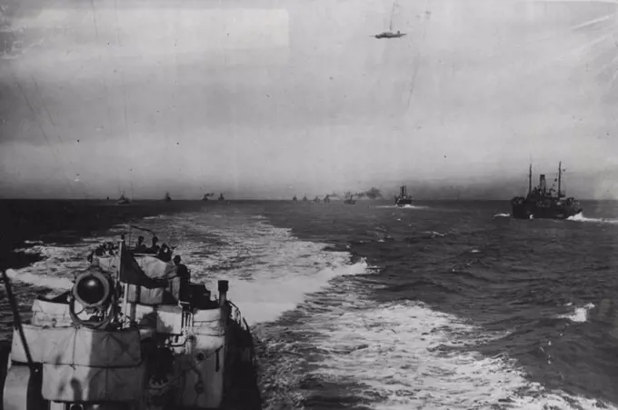 The Nation's Watchdogs: An amazing picture taken from the stern of a destroyers as rounds up the convoy, whilst a 'plane of the Coastal Command patrols overhead.''Above all'', said Mr. Churchill in a recent speech, ''we had to brig in the food and raw materials and finished munitions across the Atlantic in the teeth of the German and Italian U-boats and aircraft''. Our convoys, under the protection making their ***** to all parts of the world and this recent series of pictures, taken on board an escorting destroyer, gives some idea of the life of our seamen, when on convoy duty. February 02, 1942. (Photo by Fox Photos).