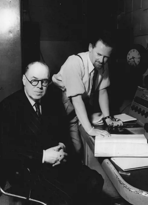 Wyndham Lewis Listens To "The Childermass" -- Wyndham Lewis author and painter, listens to a rehearsal of "The Childermass", his book which was recently adapted for radio and broadcast in the British Broadcasting Corporation's Third Programme. Behind him is D.G. Bridson, BBC feature producer, script writer and poet, who collaborated with Wyndham Lewis in the adaptation. Following on the successful broadcast of Part I of "The Childermass" - a book which was primarily conceived as a trilogy - the BBC has now commissioned Mr. Wyndham Lewis to complete Part II. October 10, 1951. (Photo by British Broadcasting Corporation).