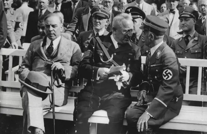 Canadian Premier at Nazi Meeting -- Mr. Mackenzie King (left) with Dr. Ley (centre) and Herr Hans Von Tschammer-Osten, German Sports Leader, at the meeting of the German Labour front at the ***** Stadium, in Berlin. Dr. Ley, on this occasion, announced that participation in active sports would in future be cumpulsory to every Great German firm.Mr. Mackenzie King, the Canadian Premier, paid a visit of several days Herr Hitler and prominent members of the Nazi Cabinet. July 01, 1937. (Photo by Keystone).