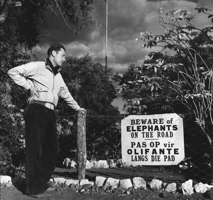 Kruger Nat. Park - A visitor from Sheffield, England, John Jeffcock, stands by the notice warning him of elephants he might meet on the road. November 25, 1948. (Photo by George Rodger, Magnum).