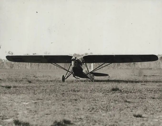 Attracted Attention -- Painted a brilliant yellow, Captain Matthews' Puss Moth was a centre of interest after the aviator landed at Eagle Far yesterday.January 20, 1931. (Photo by Brisbane Daily Mail Ltd.).