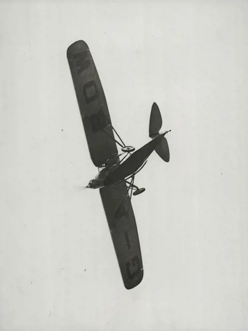 Zooming Over The Aerodrome -- Apparently its crash in Siam has not affected Captain Matthews' machine. Its is here shown zooming over the crowd at the Eagle Farm aerodrome. January 20, 1931. (Photo by Brisbane Daily Mail Ltd.).