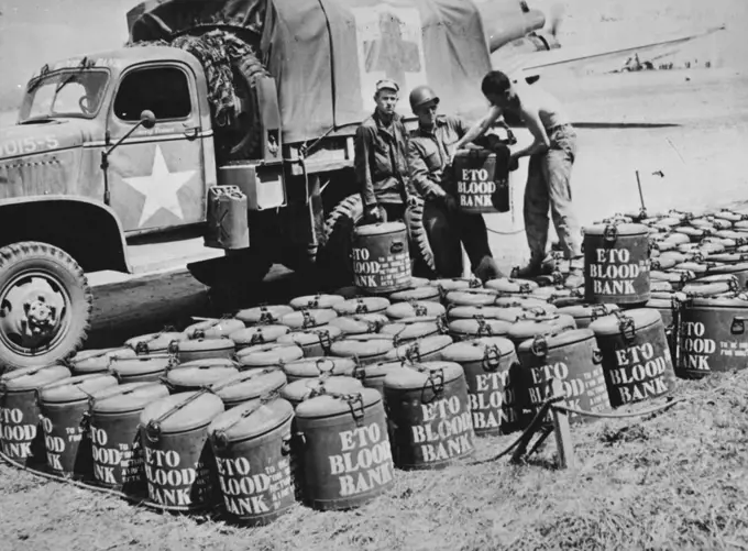 Blood For American Soldiers Injured In Normandy -- Containers of blood, to be used for transfusions for wounded American soldiers, are lined up at an airfield in Normandy after being delivered by a U. S. Amy transport plane. The American truck will carry the blood (marked ETO for the European Theater of Operations) to emergency hospitals at the front. Men and Women of the United States have donated 6,500,000 pints (4,000,000 liters) of blood to the American Red Cross for treating casualties of war. August 21, 1944.