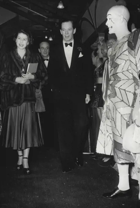 Princess Elizabeth Attends CircusAccompanied by Cyril Mills smiles as she passes Percy Huxter, the clown, when she arrived at Olympic, London, this evening, December 30, to attend Bertram Mills Circus. Behind them (centre background) is Bernard Mills. December 30, 1948. (Photo by Associated Press Photo).