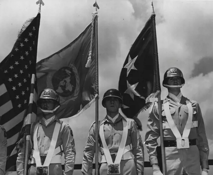 The blue and white flag of the United Nations flies between the United States flag (at left) and General Douglas MacArthur's five-star general's flag after it was presented to the general at his head-quarters in Tokyo, Japan.General MacArthur is Commander-in-Chief of the United States Amy. Far East Command, and Commanding General for the unified United Nations military forces assisting the Republic of Korea in defense against the North Korean Communist invasion. July 14, 1950. (Photo by United States Information Service).