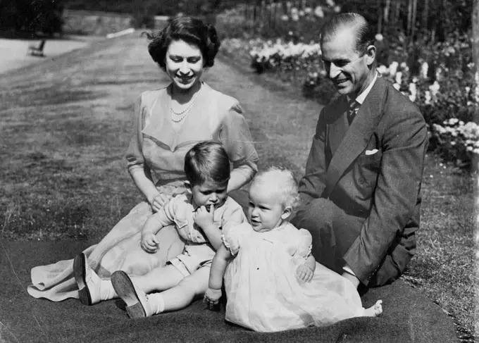 A Young Royal Family At Home -- This group, by our Cameraman Stanley Devon, was taken on the lawn in the gardens of Clarence House, the Royal Couple's London Residence.One of the busiest and hardest-working young couple in the World are Princess Elizabeth and the Duke of Edinburgh.After his return on July 21st from naval duties in the Mediterranean, the duke was immediately plunged into a round of official functions in Britain. Then on September 25 the Royal Couple will leave on a visit to Canada where they will spend several weeks as guest of the governor-general, viscount Alexander. As a conclusion to their travels on the American continent, they are to spend October 24th and 25th at the white house as guests of President Truman. August 09, 1951. (Photo by Paul Popper).