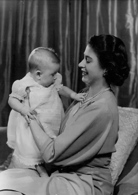 H.R.H. Princess Elizabeth And Prince Charles :First informal photograph of H.R.H. Princess Elizabeth at play with her infant son. The picture was taken in Princess Elizabeth's private sitting room at Buckingham Palace. Her Royal Highness is dressed in dove-grey. April 9, 1949. (Photo by Baron, Camera Press).