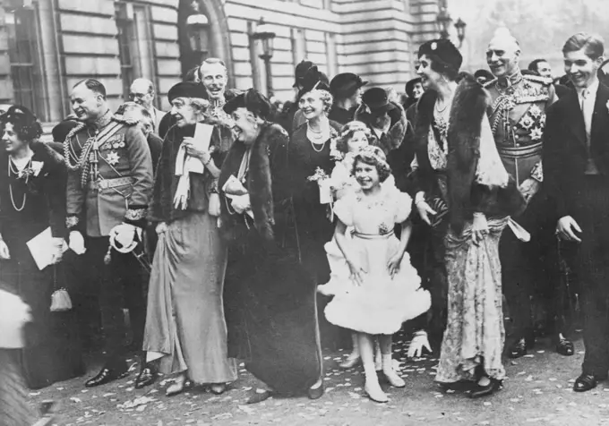 The Royal Wedding Guests Assembled In The Forscourt Of Buckingham Palace, To Bed Farewell To The Duke And Duchess Of Gloucester As They Drove To St. Pancras Station En Route For Their Honymmon -- A happy group watching the bridges and bridegroom leave the Palace.L to R. Lady Maud Carnegie, the Marquess of Cambridge, Princess Marie Louise (behind whom is Lord Carnegie), Princess Helena Victoria, the Countess of Athlane, Princess Elizabeth and behind her, Lady Mary Cambridge, Lady Patricia Ramsay, the Earl of Athlone, and Mr. A. Ramsay. November 6, 1935. (Photo by Sports & General Press Agency Limited).
