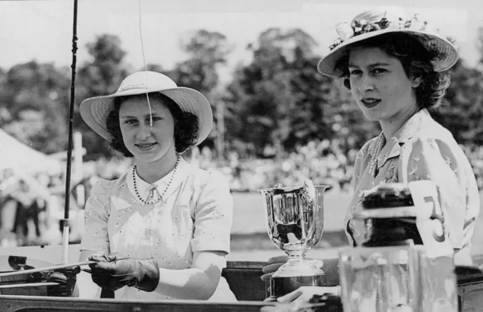 The Princesses As Winning Competitors At Windsor Horse Show -- Princess Margaret Rose (left) and Princess Elizabeth with the Silver Cup which they won for the Best Utility Single Driving Class.Princess Elizabeth. and Princess Margaret Rose were among the competitors at Windsor Horse Show and Gymkhana, held in the Home Park,Windsor. They carried off two First Prizes for the Best War Time Utility Single Driving Class and for the Best Private Single Turn Out. May 27, 1944.