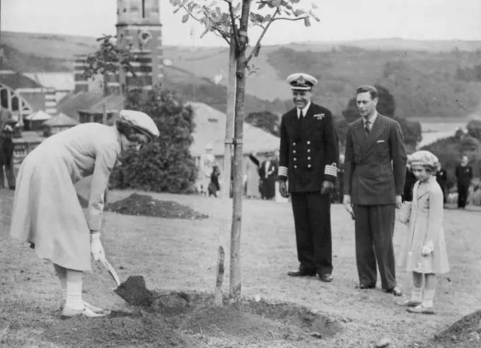 Royal Visit To Dartmouth -- Princess Elizabeth planting her tree in the College grounds, watched by the King and Princess Margaret Rose, at Dartmouth yesterday.The King and Queen and the Princess each planted a tree in the college grounds, during their visit to the Royal Naval College at Dartmouth yesterday. July 23, 1939. (Photo by Keystone).