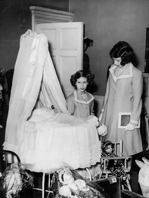 Princesses View Their Own Cot At Exhibition -- Princess Elizabeth (right ***** Princess Margaret Rose viewing the ***** both used as babies and which is now ***** was formerly their nursery.Princess Elizabeth and Princess Margaret Rose visited their old home. No.145, Piccadilly, London residence of the King and Queen when Duke and Duchess of York, to view the Exhibition of Royal and Historic Treasures, to which they, with other members of the Royal Family have contributed exhibits. The Queen recently visited the Exhibition with the King and was so impressed that she decided that the Princesses should go, too. July 28, 1939.