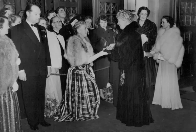 Queen Mary At Film Premiere -- H.M. Queen Mary shaking hands with Mrs. J. Arthur Rank on her arrival. On right are seen the Duchess of Marlborough with the Duchess of Gloucester. H.M. Queen Mary with the Duchess of Gloucester attended the premiere of the new British film "The Passionate Friends" at the Odeon Theatre, Marble Arch, London. January 27, 1949. (Photo by Sports & General Press Agency Limited).