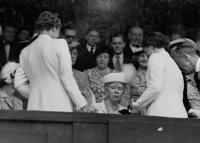 Lawn Tennis Championship Finals At Wimbledon -- H.M. Queen Mary presents the ladies Gold Salver for the singles championship to Miss Louise Brough after her match today against she has won the singles championship. July 08, 1950. (Photo by Paul Popper Ltd.).