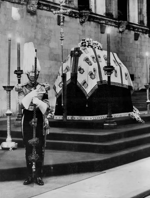 Queen Mary Lies In State -- This photo shows the scene in Westminster hall this afternoon March 29 as Queen Mary lies in state. On duty at the foot of the Catafalque is an officer of her Majesty's body guard of the honourable corps of Gentlemen-At-Arms. Others on duty (unshown) are of the Queen's Bodyguard of the Yeomen of the Guard. The Hall was opened to the public shortly after this picture was made. The lying-in-state will continue until midnight tomorrow. A Queue three quarters of a mile long waited for the doors to open. The funeral will be at Windsor on March 31. March 29, 1953. (Photo by Associated Press Photo).