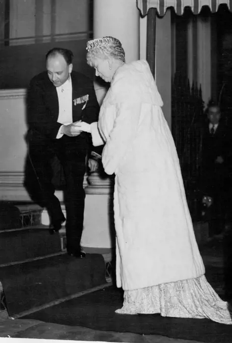 King Carol Acts As Host To British Royalty -- Queen Mary being assisted up the stairs on her arrival at the Roumanian Legation for the dinner on November 16. King Carol of Roumania was the host at the Roumanian Legation, London on November 16, The guests including the king and Queen, Queen Mary, other members of the royal family, and gave them a six course dinner, arranged by Mme. Grigorcea, wife of the Roumanian Minister in London. There were 57 guests in all, seated at a Horseshoe table. November 17, 1938. (Photo by Associated Press Photo).