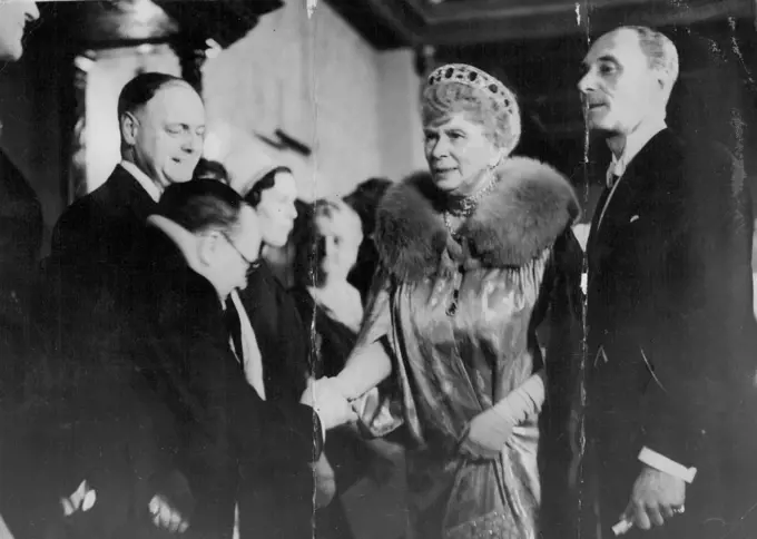 Queen Mary Attends Film Premier -- Queen Mary being received at the Plaza Theater on her arrival this evening. Queen Mary this evening attended the film premier of " Midnight " at the Plaza Theatre Haymarket. The premiere was in Aid of the Princess Beatrice Hospital. May 11, 1939. (Photo by Keystone).