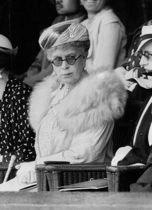 The Queen At Wimbledon Semi-Finals -- The Queen following with great interest the game between Von Cramm and Budge at Wimbledon today July 3. The Queen attended the Wimbledon championship meeting this afternoon. Her Majesty arrived during the Semi-Final match between Baron Von Cramm (Germany) and D. Budge (U.S.A) and was greeted by a burst of cheering. August 12, 1935. (Photo by Associated Press Photo).