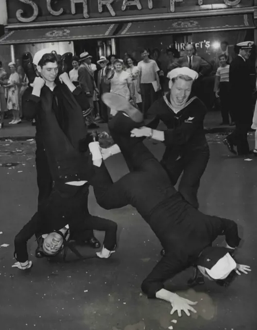 Broadway Capers -- Four sailors contributed these antics for the amusement of the many people awaiting news of the Japanese surrender in New Yorks Times Square, August 14. August 14, 1945. (Photo by Associated Press Photo).
