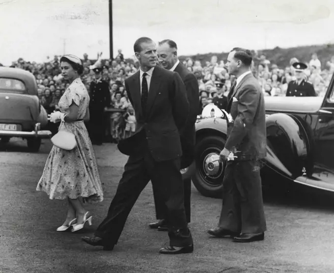 One of the most informal pictures of the Queen and Duke on the Royal visit was taken yesterday at Newcastle when they arrived at BHP to be escorted over the industrial centre by Mr. J. D. Nordgard (right). February 10, 1954.