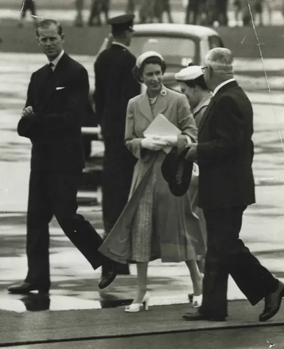 Departure - The Queen chats with Deputy Premier Heffron as she walks across the tarmac at Mascot to the Royal plane for her flight to Bathurst. Mrs. Hefforn is partly obscured. February 12, 1954.