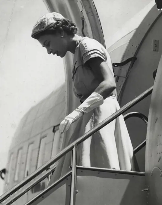 A Striking Profile of the Queen as she alights from her plane at Mascot today. The photographer has caught the Queen as she watches her step on the gangway. February 18, 1954.
