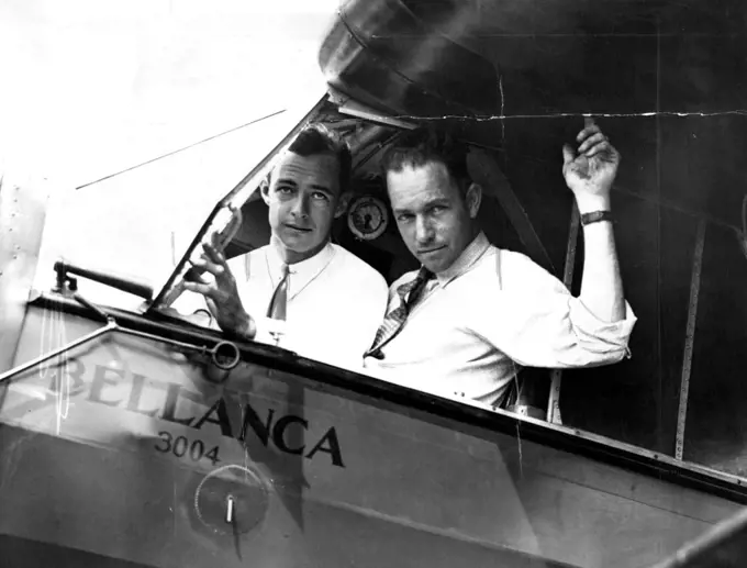 On Your Mark--Get Set --Hugh Herndon, left, and Clyde Pangborn in the Cockpit of their plane all set for their contemplated hop across the Atlantic ocean. They will most likely be the newest members to the exclusive "Ocean-Crossers" club whose ranks have swollen this year in unprecendented fashion. They will try to Gridle the Entire Globe. June 26, 1931. (Photo by International Newsreel Photo).