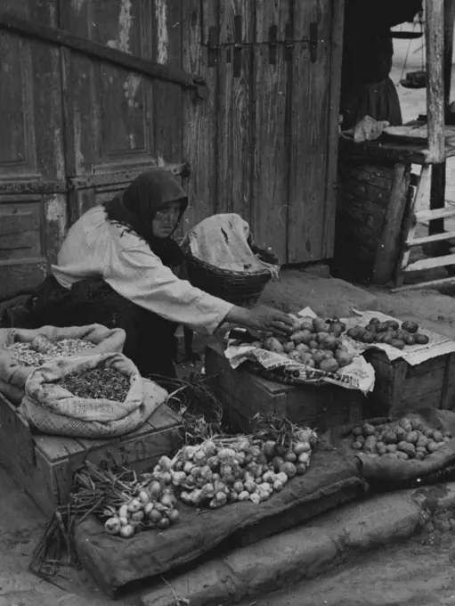 Bessarabia, Former Province of The U.S.S.R.A Bessarabian peasant selling vegetables in the street of Hotin, Northern Bessarabia, a town which may assume great political significance. November 16, 1939. (Photo by Kosmos Press Bureau (Australasia) Pty. Ltd.).