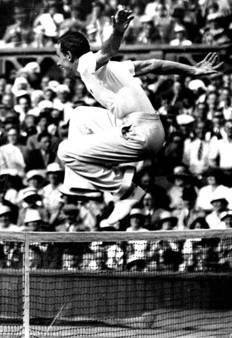 Perry's Victorious Leap!F.J. Perry delightedly jumps the net to shake hands with his opponent S.B. Wood after their match.Gt. Britain and Australian to meet in the finals at Wimbledon.Fred Perry by defeating S.B. Wood (U.S.A.) July 4th., in the semi-finals of the men's singles championships at the Wimbledon tennis, now meets Jack Crawford (Australia) in the finals. August 06, 1934.