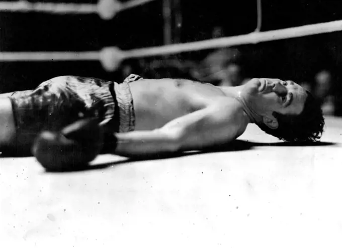 Doyle Knocked Out In The First Round -- Jack Doyle on his back in the centre of the ring after being knocked out in the first round.Eddie Phillips, the Bow (London) heavyweight, knocked out Jack Doyle, the Irish heavyweight, in the first round of their return match at the White City, London to-night They fought last September,when Phillips was the winner Doyle being counted out in the second round after falling out of the ring.The "horizontal heavyweight." Eddie Phillips knocked Doyle out in the first round of their fight at the White City. At their previous meeting Phillips won in the second round. July 10, 1939. (Photo by Topical Press).