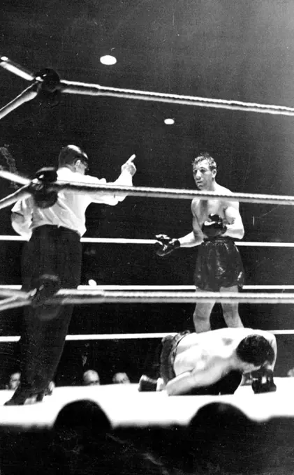 Philips Knocks Out Foord In The Ninth Round -- The ***** of the fight Ben Foord being counted  out while Philips looks on. June 21, 1938.