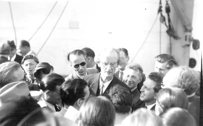 Piccard Leaving On World's Greatest Deep Sea Diving Expedition -- Professor Auguste Piccard is surrounded by reporters aboard the 4,000-ton steamer "Scaldis" here just before his departure with his friend and colleague, Professor Max Cosyns, for the Gulf of Guinea, off the coast of West Africa, with their bathyscaphe, for the greatest deep-sea diving expedition of modern times.The Piccard-Cosyns expedition is of much scientific importance - for the man who made the world gasp with astonishment 17 years ago by going up 10 miles in a balloon, will enter the steel bathyscaphe with his partner Cosyns - and descend 2½ miles into the black depths of the ocean. September 13, 1948.