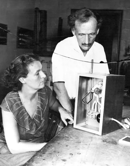 Piccards prepare for another stratosphere flight: Mr. and Mrs. Piccard with Barometer they will use to tel the height of their proposed flight. Mr. and Mrs. Jean Piccard are making final preparations for their planned forthcoming stratosphere flight. July 31, 1934. (Photo by Wide World Photos)