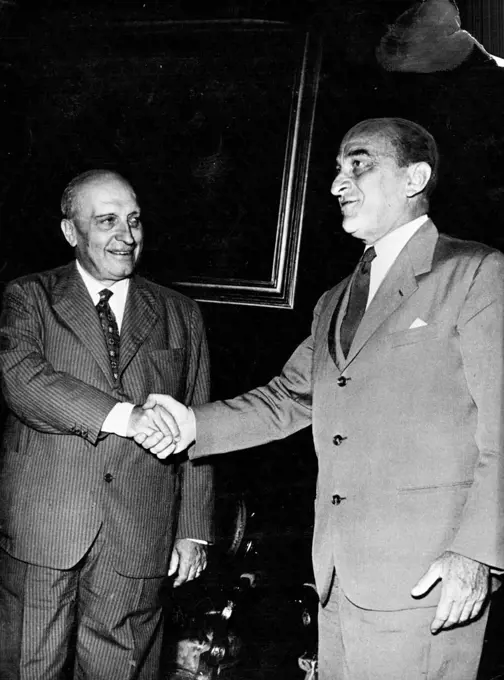 Italian Politicians: Attilio Piccioni -- Attilio Piccioni, second in command of the Italian Christian Democrat Party, was invited by the President of Italy to form a new Cabinet, but failed. Our photograph shows Senor Piccioni (left) shaking hands with Giovanni Gronchi, President of the Chamber. August 21, 1953. (Photo by Camera Press).