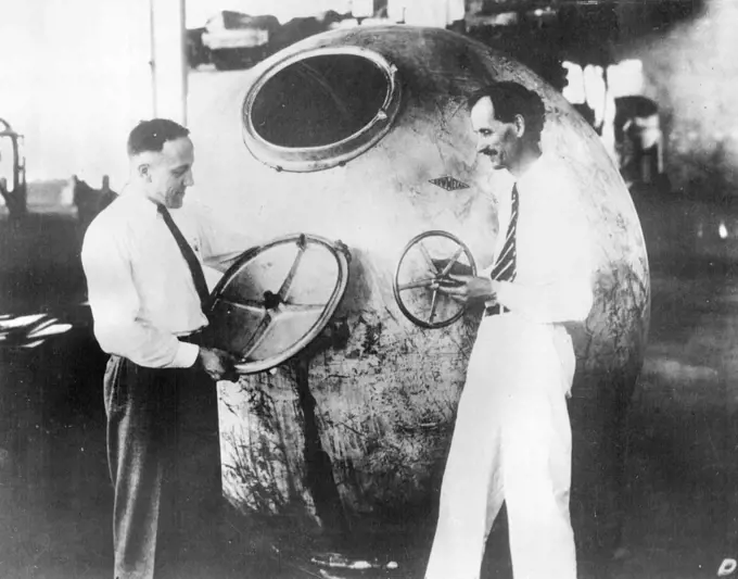 Professor Jean Piccard And Commander Settle Make Stratosphere Ascent -- Professor Jean Piccard (right) and Lieut. Commander T.G.W. Settle inspecting their gondola.Professor Jean Piccard and Lieut. Commander T.G.W. Settle of the United States Navy were scheduled to make their journey into the stratosphere. Professor Piccard is a twin brother of Professor Auguste Piccard who ascended to a height of ten miles last year. This time it is hoped to reach a height of 17 miles over Chicago in a special gondola. July 19, 1933.