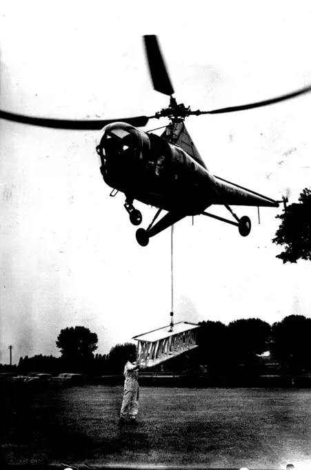 Aerial Crane. The "Westland Sikorsky," the first commercial-type helicopter available in Europe demonstrates how it can drop its own hoisting gear and while hovering, pick up a steel girder, offering an easy method of bridging a river from the air. The aircraft accommodates a pilot and three passengers in a luxury cabin, air-conditioned and warmed. June 1, 1947. (Photo by Sport & General Press Agency, Limited).