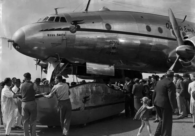The Speed Pak being wheeled away from the plane. This new luggage carrying device was seen for the first time when the new Cams Lockheed Constellation arrived at Mascot today. It is the first of 4 of this type of aircraft to arrive in Sydney for Qantas. October 14, 1947. (Photo by Ernest Charles Bowen/Fairfax Media).
