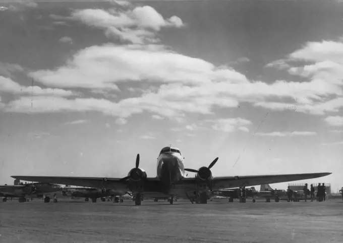 D.C.3 aircraft at Mascot prior to departure on first flight of Sydney-New Gunea service. April 2, 1945. (Photo by Richard McKinney, Qantas Empire Airways Limited).