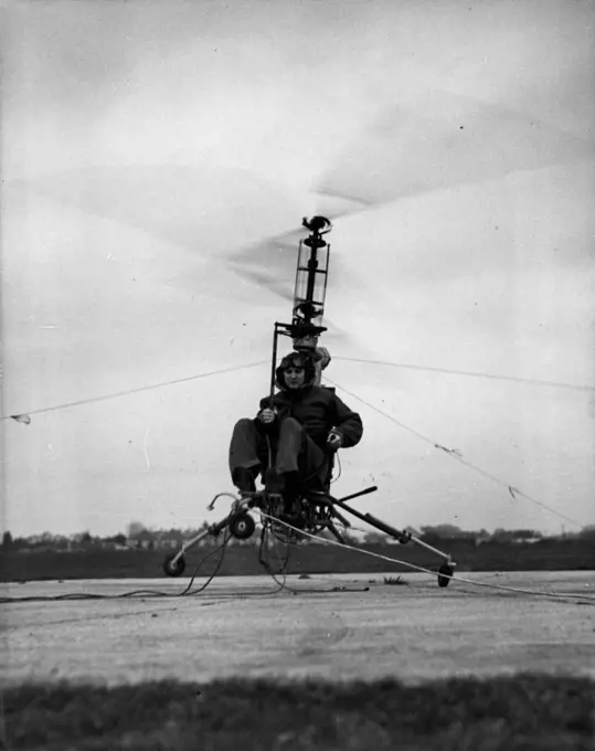 Flying Motor-Cycle Tames The Air -- The 'Hoppicopter' motor-cycle of the air, took the air - in a very small dose - in its first engine tests at Somerford Aerodrome, Christchurch, Hampshire. The 'Hoppicopter' based on the machine designed by the American, H.T. Pentecost, was airborne for only a few minutes, for it was tethered by steel cables. Mr. Berry Martin, managing director of the Winton (Hampshire) factory that built the midget flying machine, piloted it on its first hop. December 12, 1949.