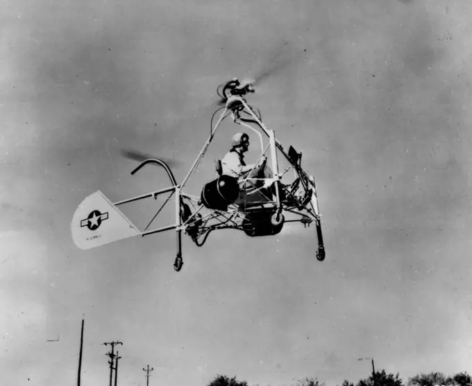 Helicopter Motorcycle In Flight -- The Air Forces' New Helicopter motorcycle, powered by ram jet units to spin the rotor blades, makes a test flight at the St. Louis, Mo., plant of the McDonnel Aircraft corporation. The craft eights only 310 pounds but has lifted an additional load of 300 pounds and moved at a speed of 50 miles an hour. November 15, 1947. (Photo by Associated Press Photo).