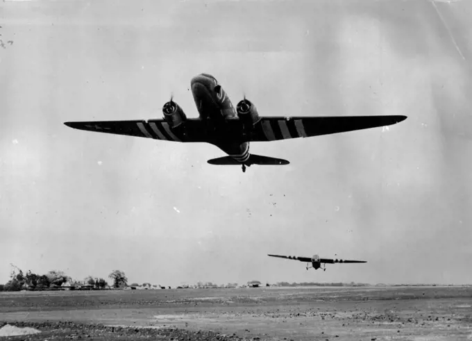 A Ninth Air Force Troop Carrier Command Station -- A C-47 transport is shown pulling a British-built "Horsa" type glider loaded with Yank air bone infantry, into the air in the early morning of 6th. June as the Ninth Air Force Troop Carrier Command sends reinforcements to the Para-trooper dropped behind Nazi line in France earlier the same day. September 4, 1944. (Photo by U.S. Official Photograph).