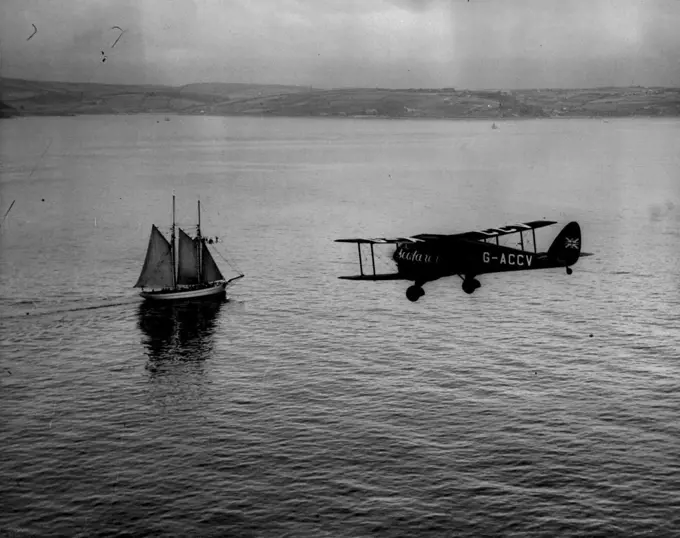 The Mollison Flight - Air Views as "Seafaber" Crosses Ireland. - "The Seafarer" passing a Schooner off Cork Harbour.A series of Aerial views taken from an accompanying aeroplane, showing "Seafarer" with Mr. and Mrs. J.A. Mollison abroad, passing the Irish coast en route for a America, over the Atlantic. They succeeded in the crossing but unfortunately crashed at Bridgeport Connecticut. Both are now in Hospital. July 25, 1933. (Photo by Associated Press Photo).