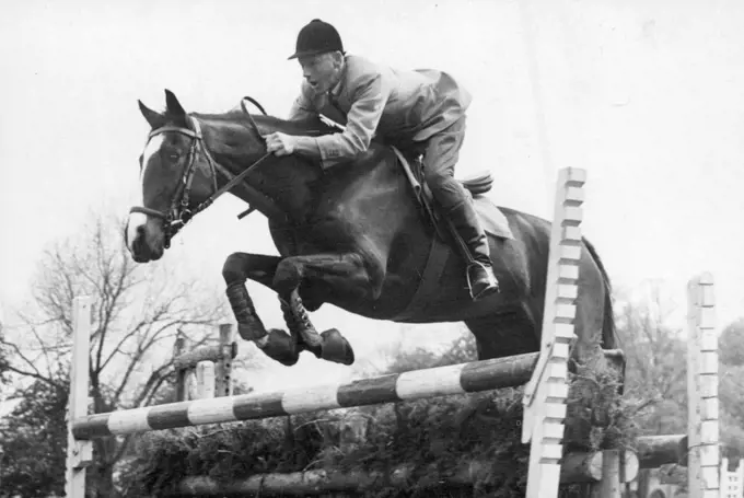 Photo Shows: Mr. Ern barker in action during training at Aldershot. Australian Horsemen in England.The Equestrian team to represent Australia in the Olympic games at Stockholm in 1956 are now in training at Aldershot . The team will compete in various show jumping and combined Events ***** in Britain and on the continent as part of their training and is the first equestrian team ever to represent Australian in the Olympic Games. May 18, 1955.  (Photo by Sport & General)