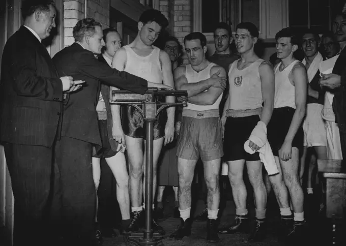 A.B.A. Searcres For Olympic Team - Aspirants for Britain's Olympic Games boxing team line up for the Weigh-in before training this afternoon. On the scales Ron Bebbington. Imperial Services middle-weight champion.The Amateur Boxing Association are holding a series of weekend courses in the theory and practice of boxing in an effort to select the best possible team for the Olympic Games. At a typical meeting of the course at Nelson School, Tranalgar St., Walworth, today, the boxers attending were given lectures on morale, Physical training treatment of injuries, etc., by exports. January 03, 1948. (Photo by Fox).