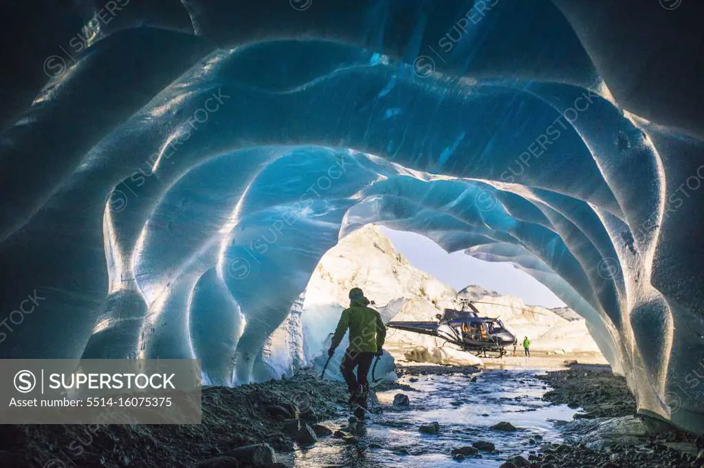 Ice climber retreats back to helicopter after a day of climbing.