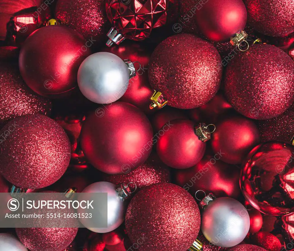 Close up of a variety of red and white Christmas ball ornaments.