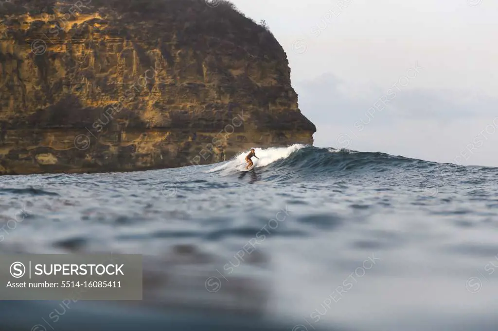 Young woman surfing in Indian Ocean