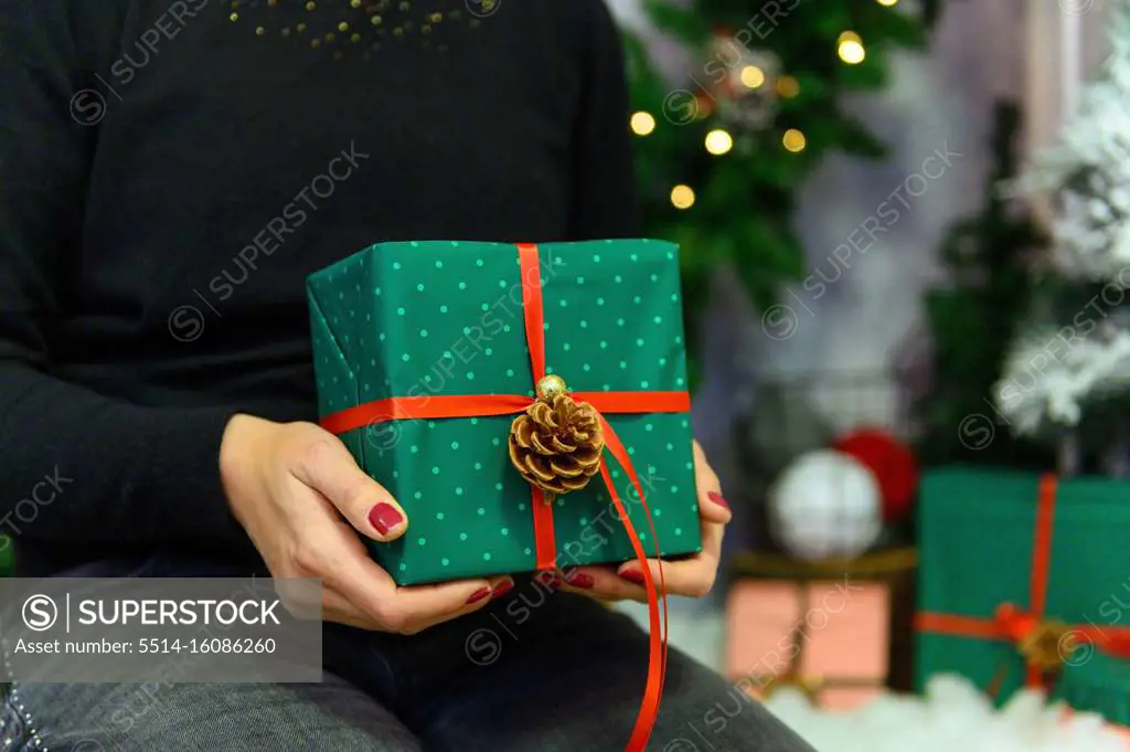 Christmas gift. Congratulations.Top wiew of woman holding tradit