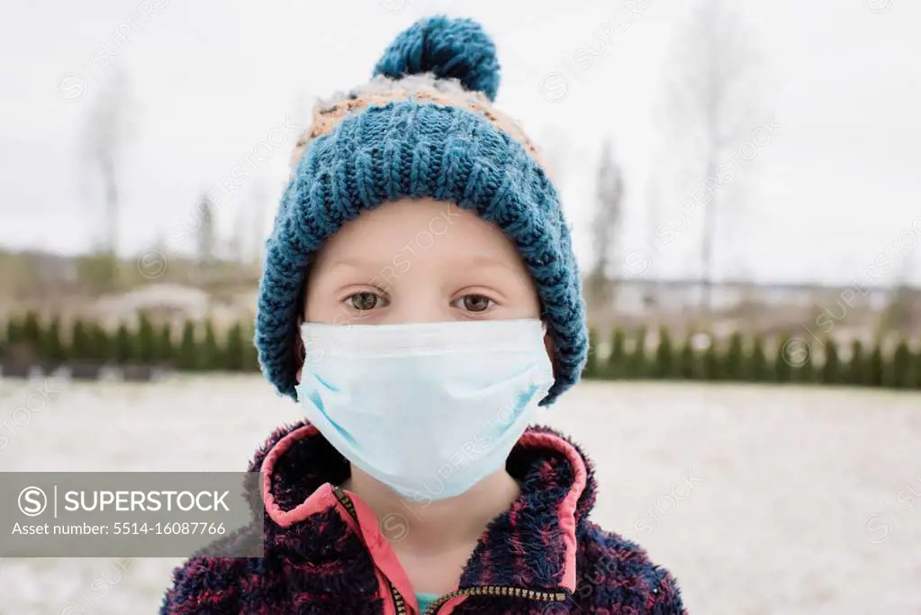 young boy with face mask on protecting himself from flu and virus