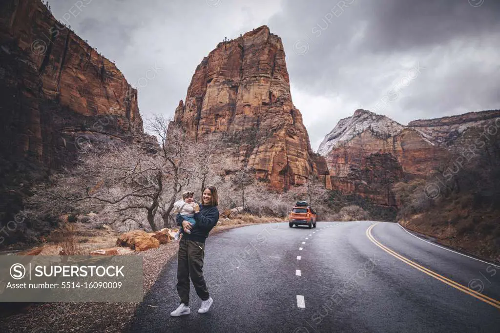 A woman with a child is walking in Zion National Park, Utah